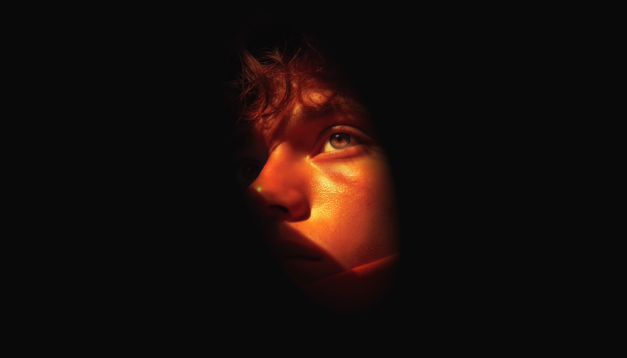 a yellow person in dark background